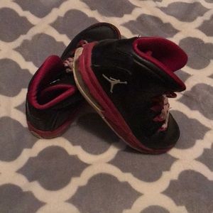 fuchsia pink and black Jordan’s